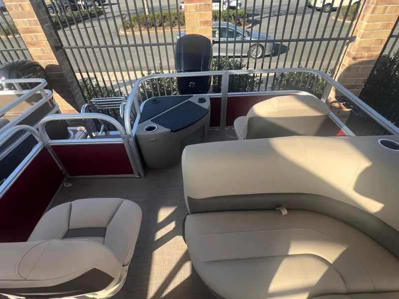 Slide: The Image of 2025 Sun Tracker Bass Buggy 18 DLX pontoon boat interior with beige seating. - 3