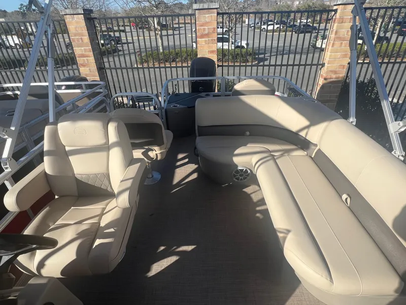 Slide: The Image of 2025 Sun Tracker Bass Buggy 18 DLX pontoon boat with beige seating and spacious interior. - 5