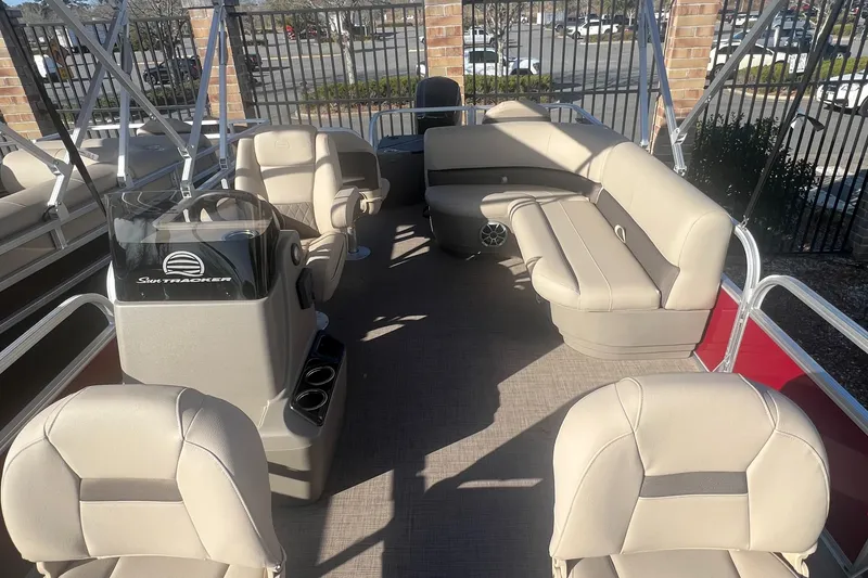 Slide: The Image of 2025 Sun Tracker Bass Buggy 18 DLX pontoon boat interior with beige seating. - 6
