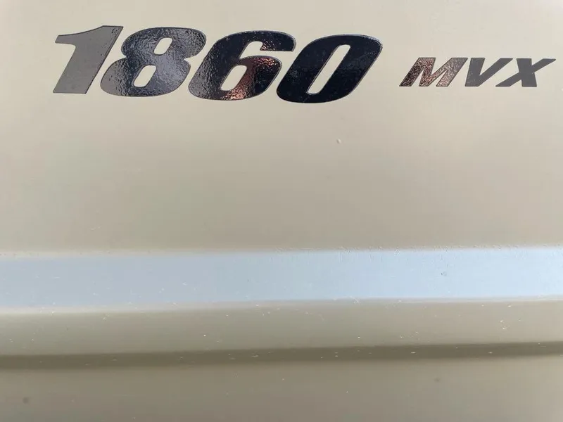 Slide: The Image of 2025 Tracker Grizzly 1860 CC boat model logo on beige surface. - 2