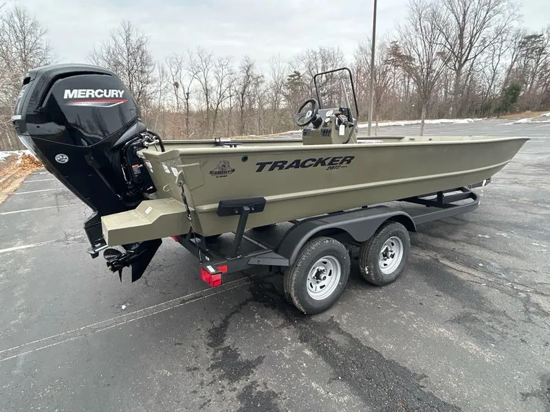 Slide: The Image of 2025 Tracker Grizzly 2072 CC boat with Mercury engine on trailer in parking lot. - 2