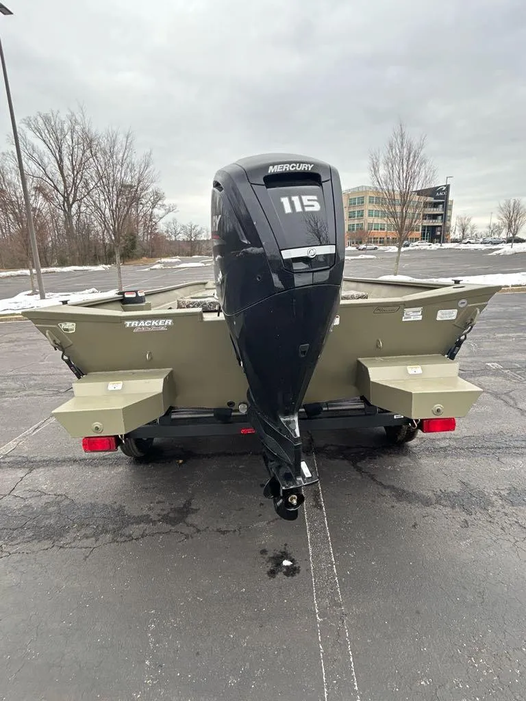 Slide: The Image of 2025 Tracker Grizzly 2072 CC boat with Mercury 115 outboard motor, parked outdoors. - 3