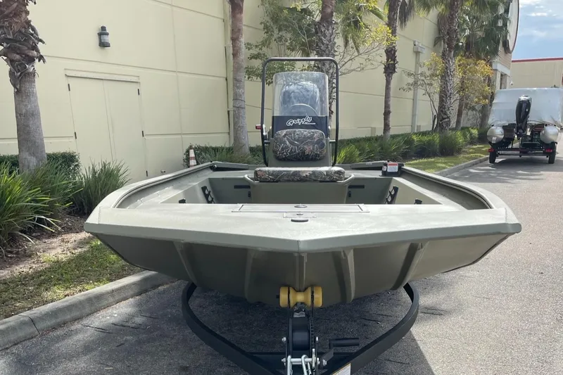 Slide: The Image of 2025 Tracker Grizzly 1860 CC boat on trailer, parked outdoors. - 2