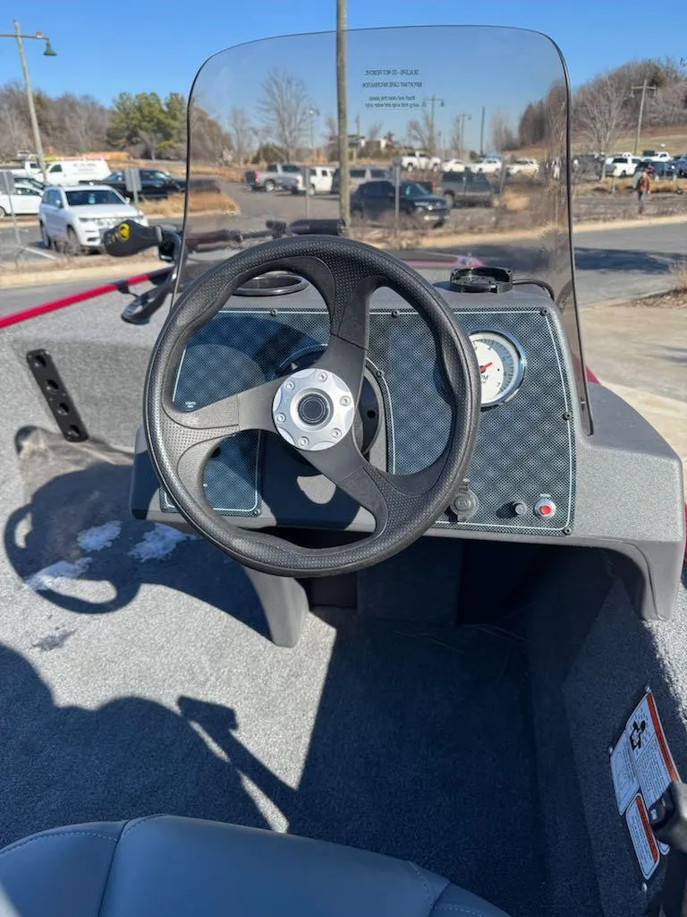 Slide: The Image of 2025 Tracker Bass Tracker Classic XL boat dashboard with steering wheel and gauges. - 4