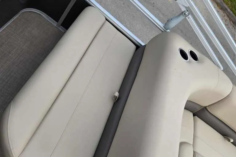 Slide: The Image of 2025 Sun Tracker Party Barge 18 DLX beige seating with cup holders. - 10