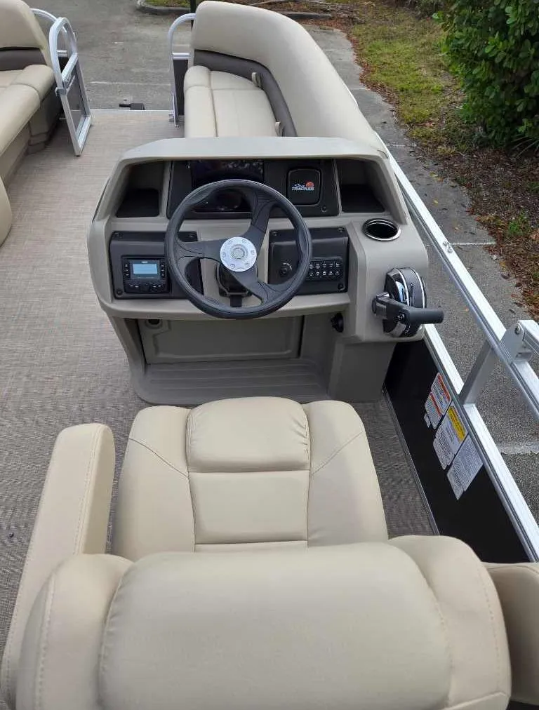 Slide: The Image of 2025 Sun Tracker Party Barge 18 DLX interior with steering console and seating. - 5