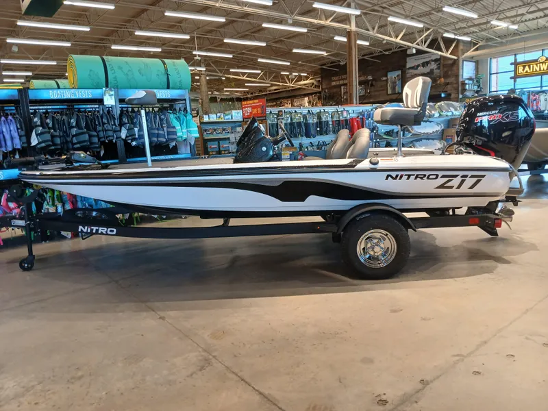 The Image of 2025 Nitro Z17 boat displayed in a showroom with fishing gear. - 0