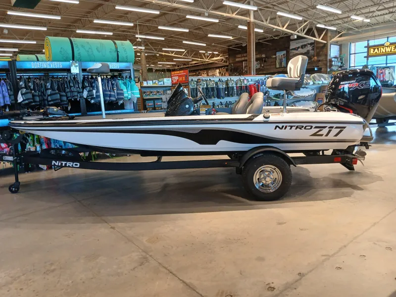 Slide: The Image of 2025 Nitro Z17 boat displayed in a showroom with fishing gear. - 28