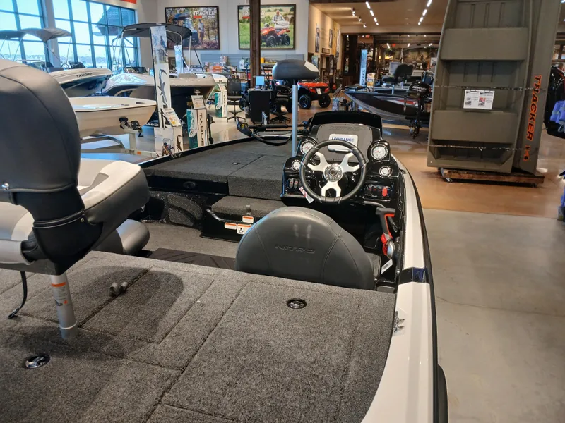 Slide: The Image of 2025 Nitro Z17 boat interior with steering wheel and seating in showroom. - 4