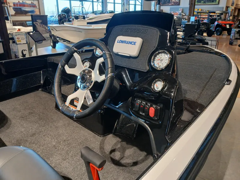 Slide: The Image of 2025 Nitro Z17 boat dashboard with steering wheel and Lowrance display. - 5