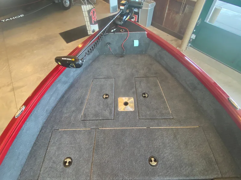 Slide: The Image of 2025 Ranger VS1665T boat interior with carpeted deck and storage compartments. - 4