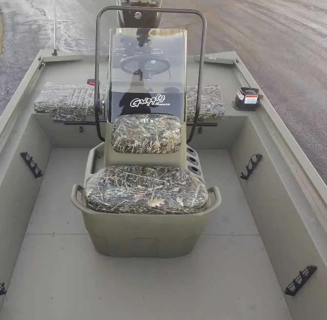 Slide: The Image of 2025 Tracker Grizzly 1860 CC boat interior with camouflage seating and steering console. - 3