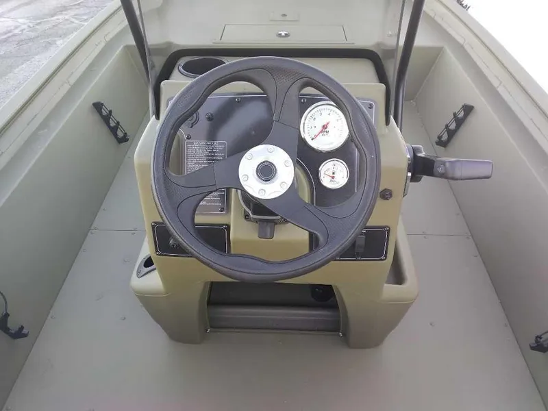 Slide: The Image of 2025 Tracker Grizzly 1860 CC boat console with steering wheel and gauges. - 4