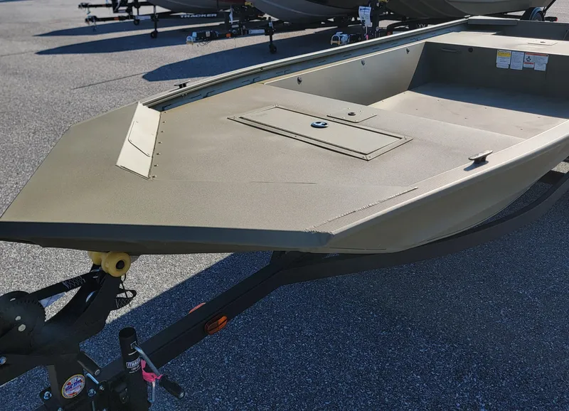 Slide: The Image of 2025 Tracker Grizzly 1648 Jon boat on trailer, parked outdoors. - 2