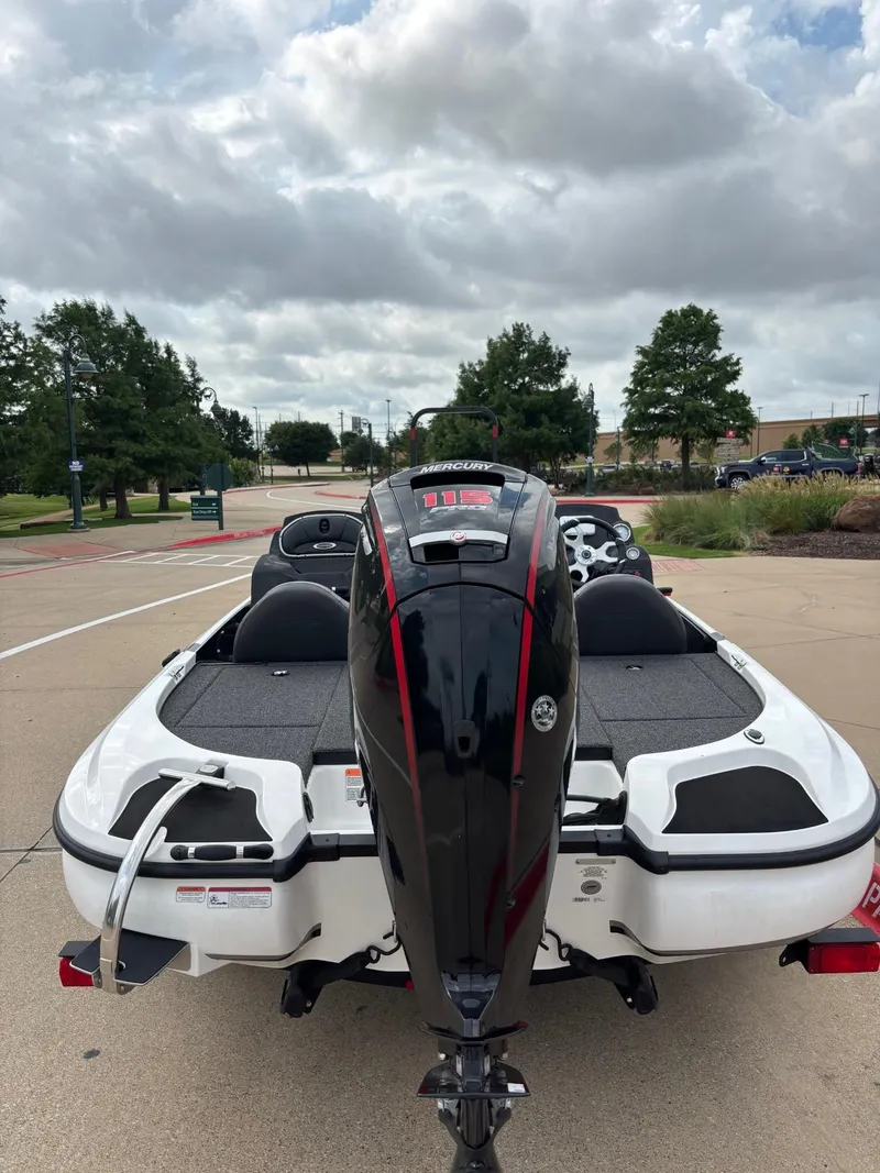 Slide: The Image of 2025 Nitro Z17 boat interior with steering console and Lowrance electronics, parked on pavement. - 3