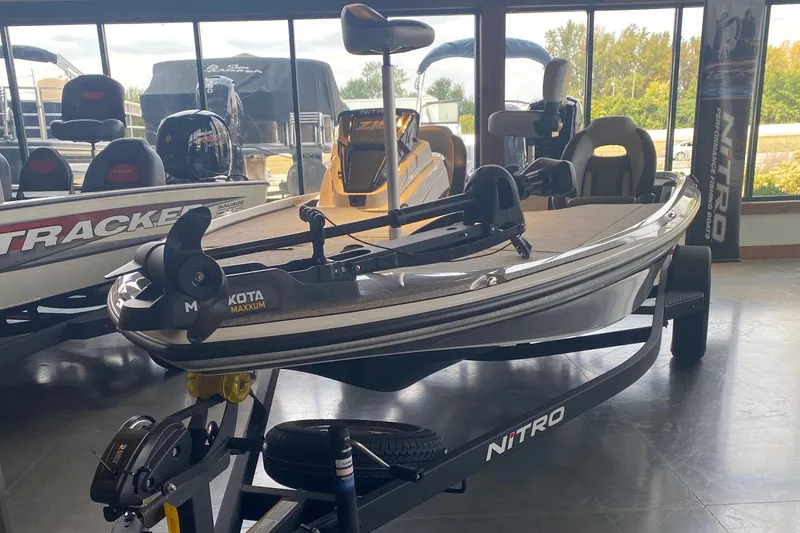 The Image of 2025 Nitro Z18 fishing boat displayed indoors with Minn Kota Maxxum motor. - 0