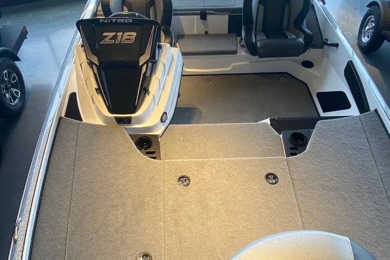 Slide: The Image of 2025 Nitro Z18 boat interior with seating and carpeted deck. - 4