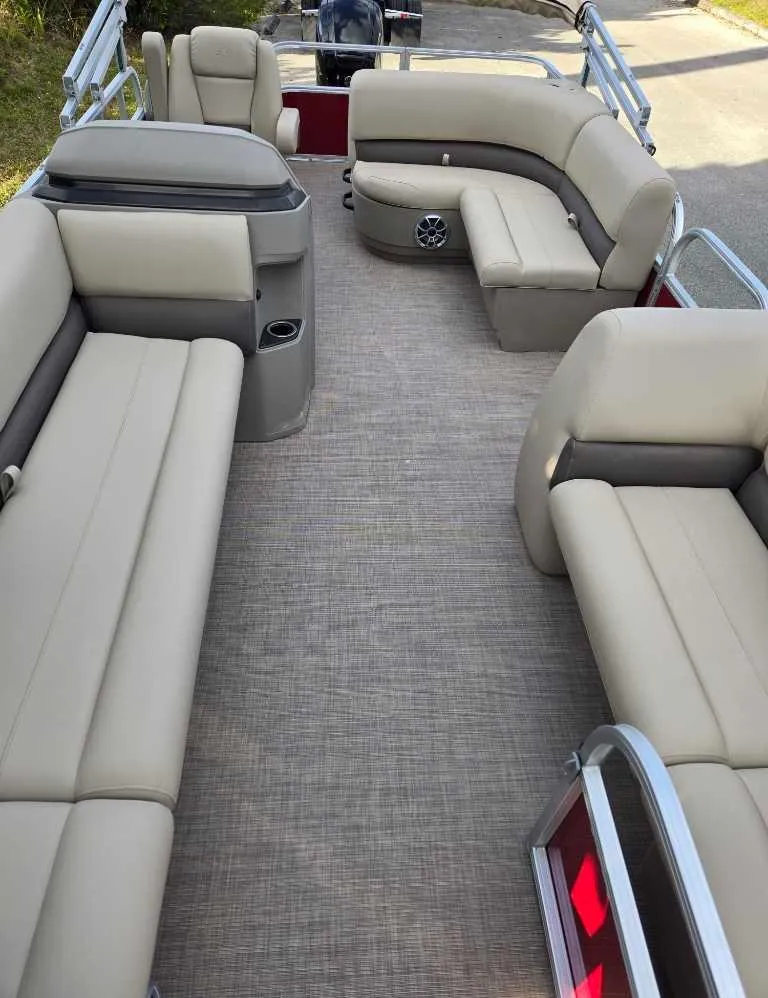 Slide: The Image of 2025 Sun Tracker Party Barge 18 DLX interior with beige seating and spacious layout. - 6
