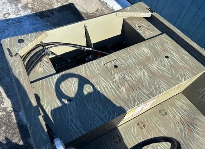 Slide: The Image of 2024 Tracker Grizzly 1648 SC boat interior with camouflage pattern and steering wheel. - 10