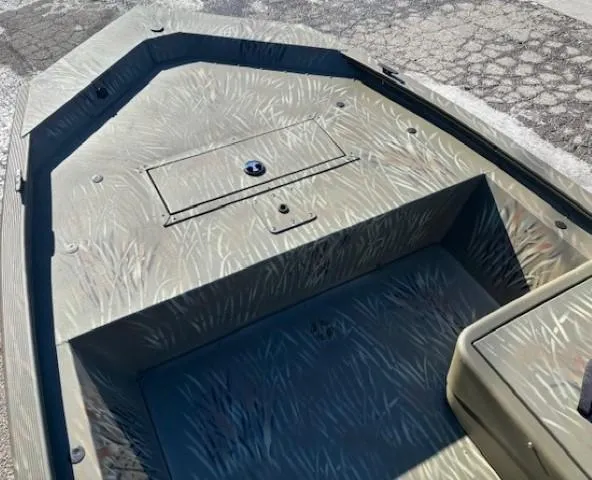 Slide: The Image of 2024 Tracker Grizzly 1648 SC boat interior with camouflage design. - 4