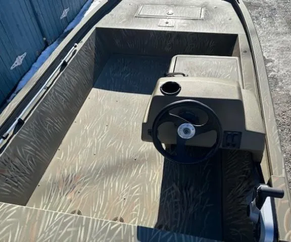 Slide: The Image of 2024 Tracker Grizzly 1648 SC boat interior with steering console and camouflage design. - 9