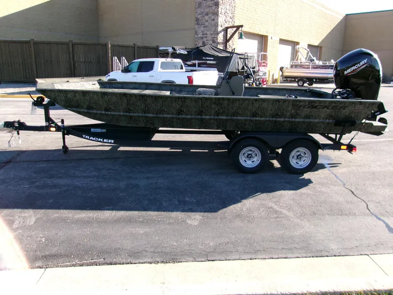 Slide: The Image of 2025 Tracker Grizzly 2072 CC boat on trailer, parked outdoors. - 2