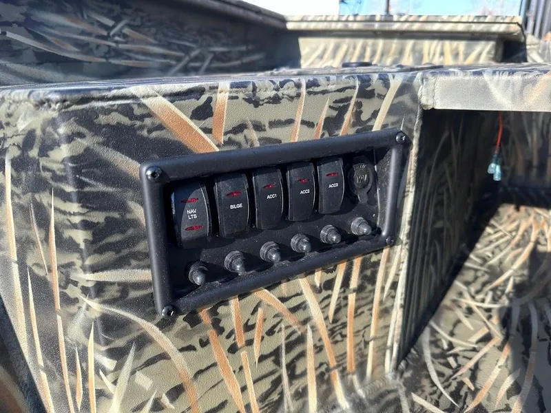 Slide: The Image of Control panel on 2025 Tracker Grizzly 1650 T Prairie Wings Edition boat with camouflage design. - 14
