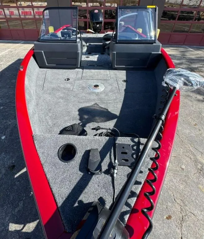 Slide: The Image of 2025 Tracker Pro Guide V-175 WT boat interior with red trim and fishing equipment. - 3