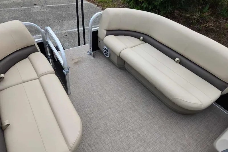 Slide: The Image of 2025 Sun Tracker Party Barge 16 DLX interior with beige seating and spacious layout. - 8