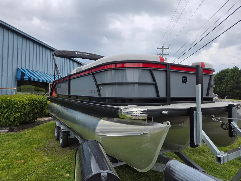 The Image of 2025 Godfrey SWEETWATER 2286 SFL pontoon boat on trailer, parked outdoors. - 0