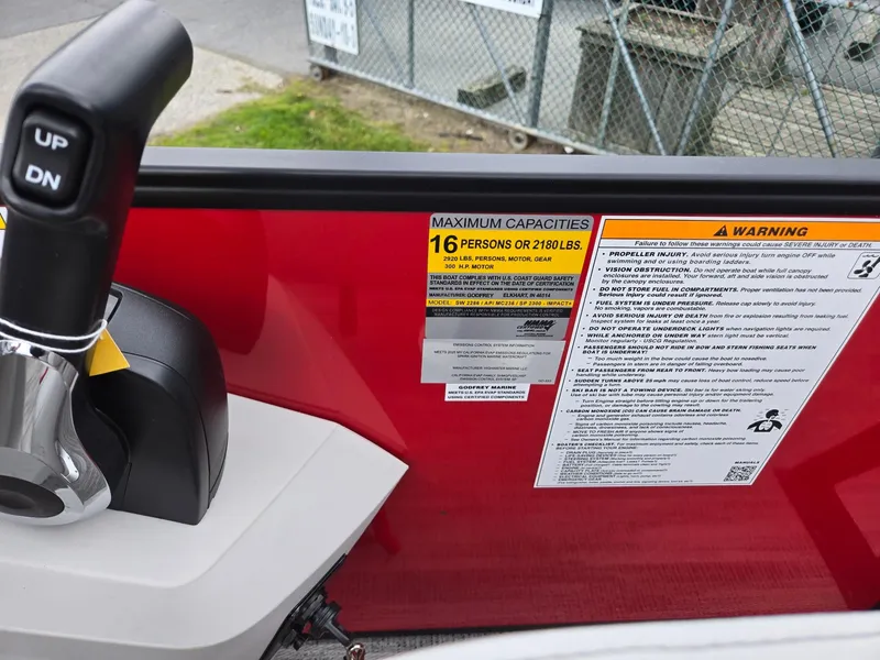 Slide: The Image of 2025 Godfrey SWEETWATER 2286 SFL boat capacity label, 16 persons or 2180 lbs, with control lever. - 17