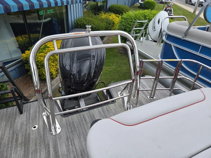 Slide: The Image of 2025 Godfrey SWEETWATER 2286 SFL boat with chrome railing and outboard motor. - 21