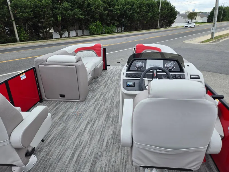 Slide: The Image of 2025 Godfrey SWEETWATER 2286 SFL pontoon boat interior with modern seating and steering console. - 26
