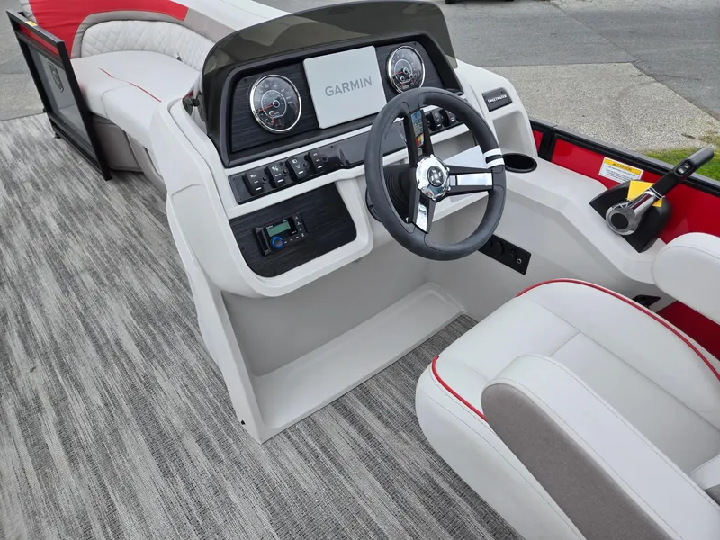 Slide: The Image of 2025 Godfrey SWEETWATER 2286 SFL boat interior with Garmin dashboard and modern steering wheel. - 29