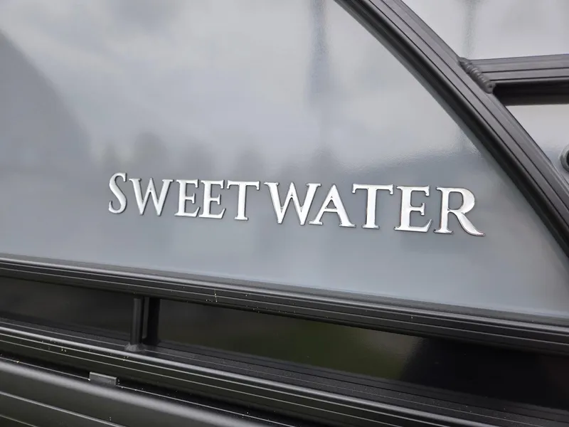 Slide: The Image of 2025 Godfrey SWEETWATER 2286 SFL boat logo on sleek exterior surface. - 33