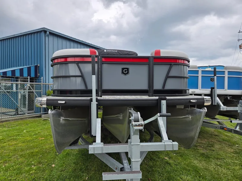 Slide: The Image of 2025 Godfrey SWEETWATER 2286 SFL pontoon boat on trailer, parked on grass. - 4