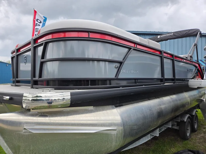 Slide: The Image of 2025 Godfrey SWEETWATER 2286 SFL pontoon boat on trailer, displayed outdoors. - 5