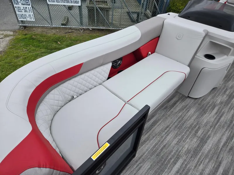 Slide: The Image of 2025 Godfrey SWEETWATER 2286 SFL boat interior with red and gray seating. - 7