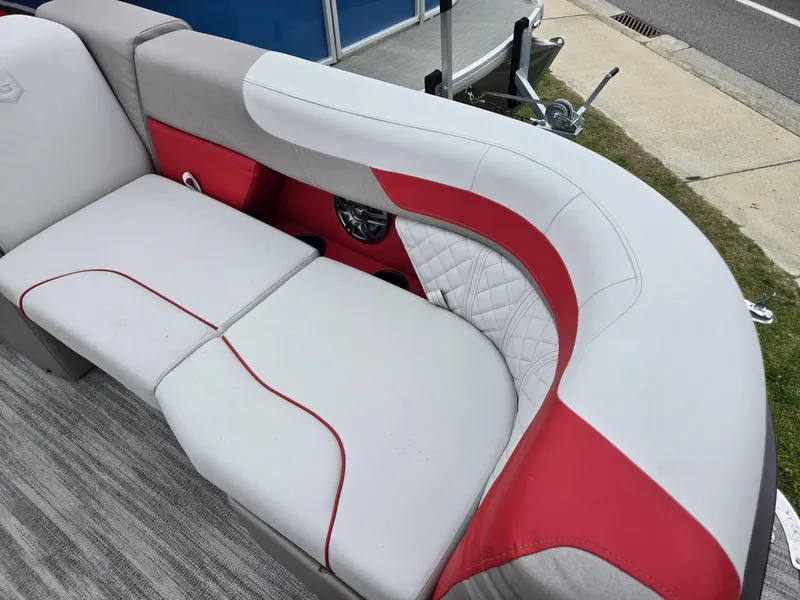 Slide: The Image of Luxurious seating on 2025 Godfrey SWEETWATER 2286 SFL pontoon boat, featuring red and white upholstery. - 8
