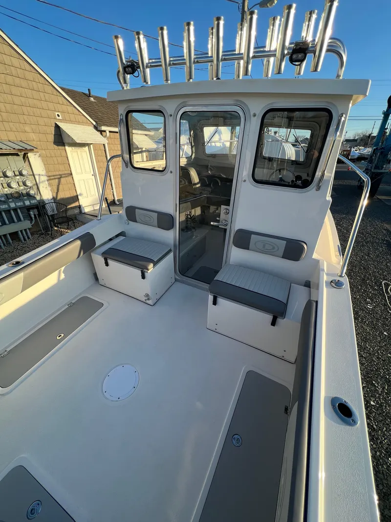 Slide: The Image of 2025 Defiance Admiral 220 EX boat with spacious deck and seating. - 11