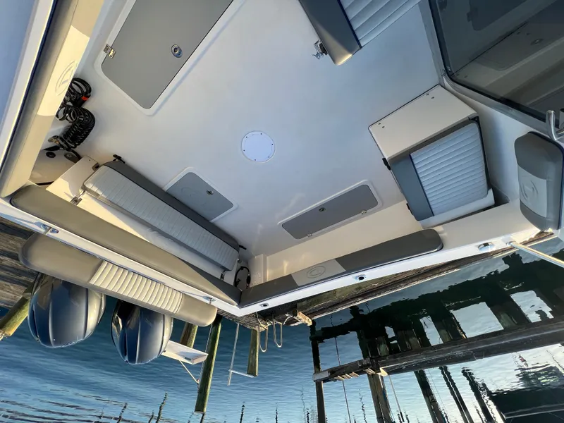 Slide: The Image of 2025 Defiance Admiral 220 EX boat interior with seating and storage compartments. - 13