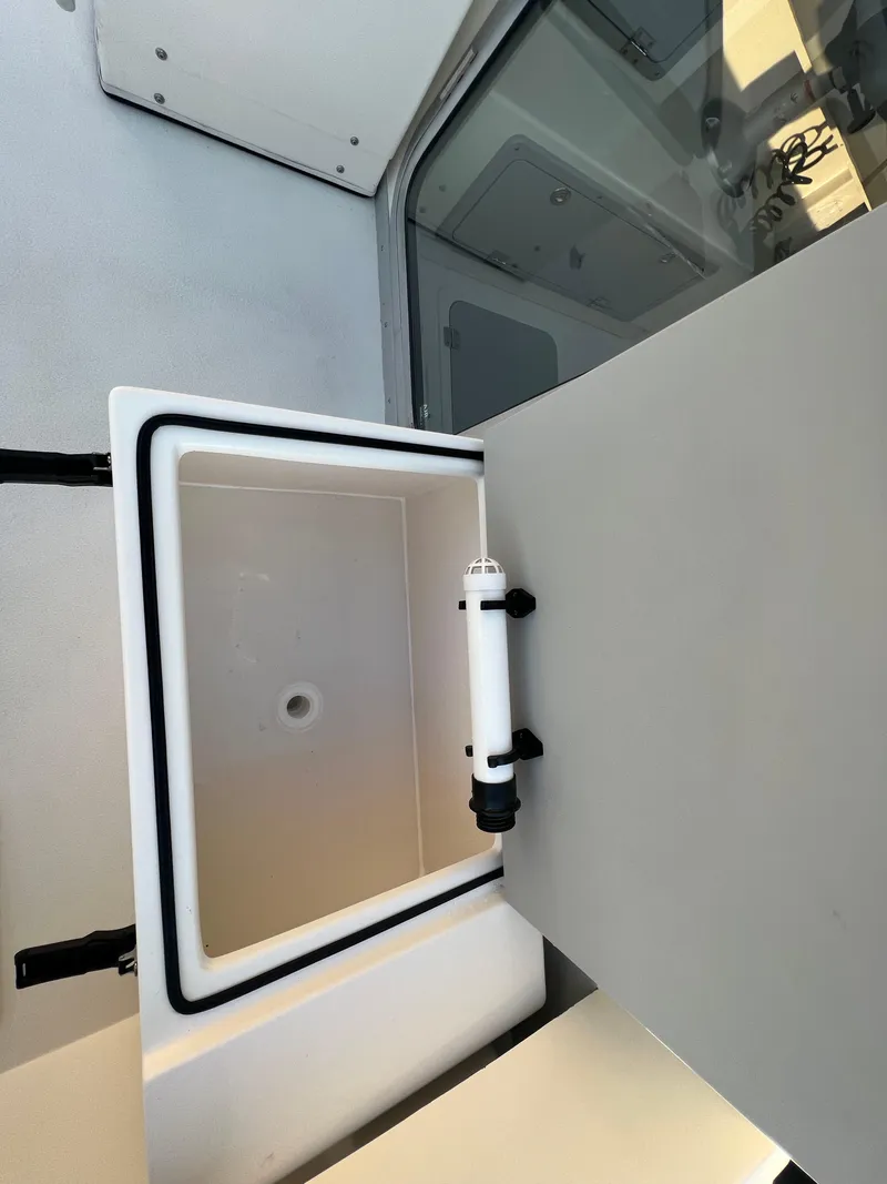 Slide: The Image of 2025 Defiance Admiral 220 EX boat interior storage compartment open. - 15