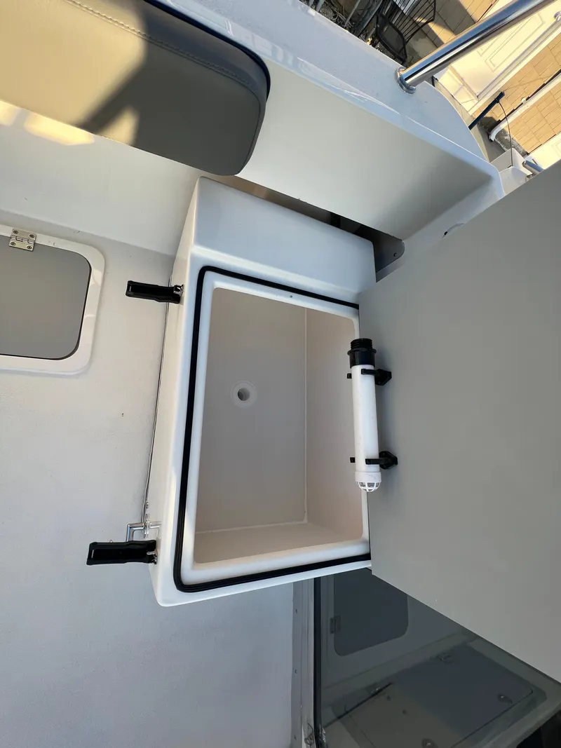 Slide: The Image of 2025 Defiance Admiral 220 EX boat interior with open storage compartment. - 16