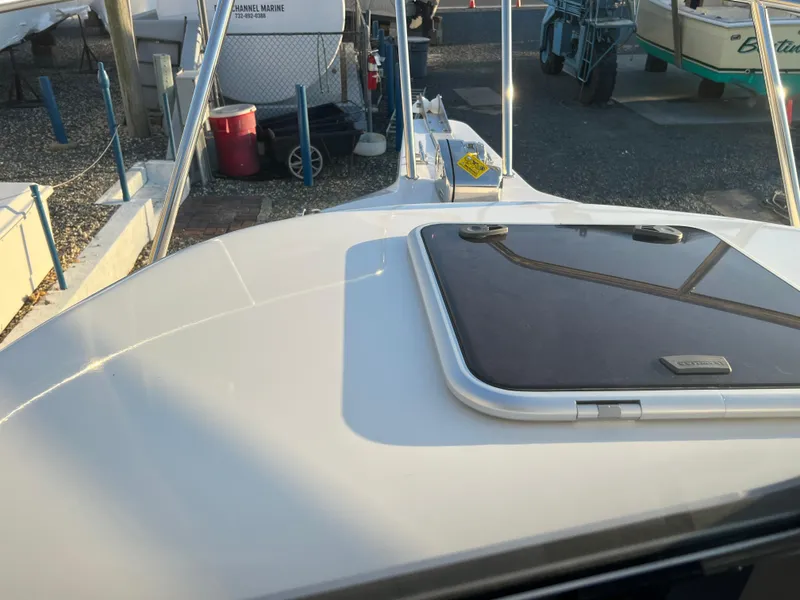 Slide: The Image of 2025 Defiance Admiral 220 EX boat deck with hatch, docked in marina. - 29