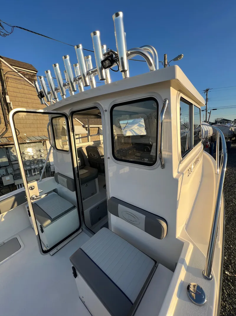 Slide: The Image of 2025 Defiance Admiral 220 EX boat, featuring a sleek cabin and multiple rod holders. - 31