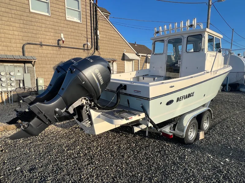 Slide: The Image of 2025 Defiance Admiral 220 EX boat on trailer with Yamaha outboard motor. - 4