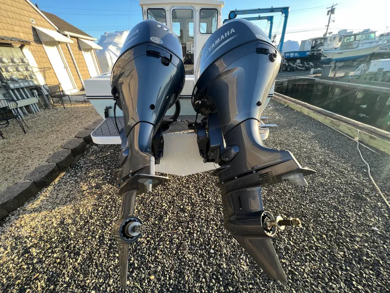 Slide: The Image of Twin Yamaha outboard motors on a 2025 Defiance Admiral 220 EX boat. - 5