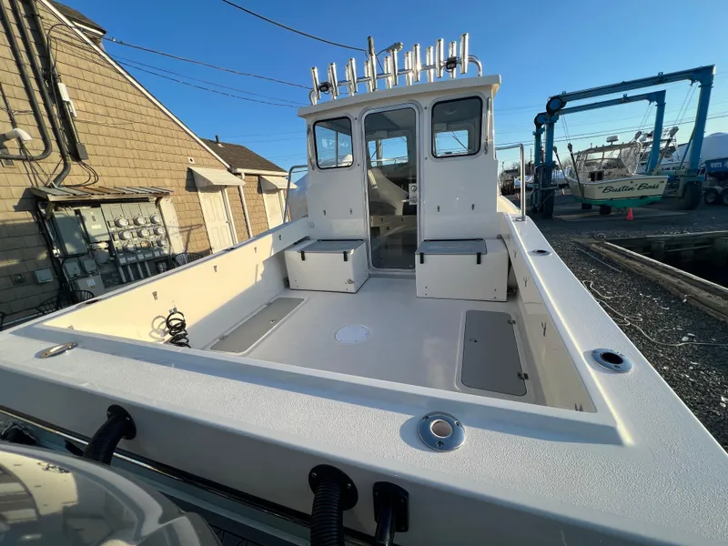 Slide: The Image of 2025 Defiance Admiral 220 EX boat with spacious deck and fishing rod holders. - 7