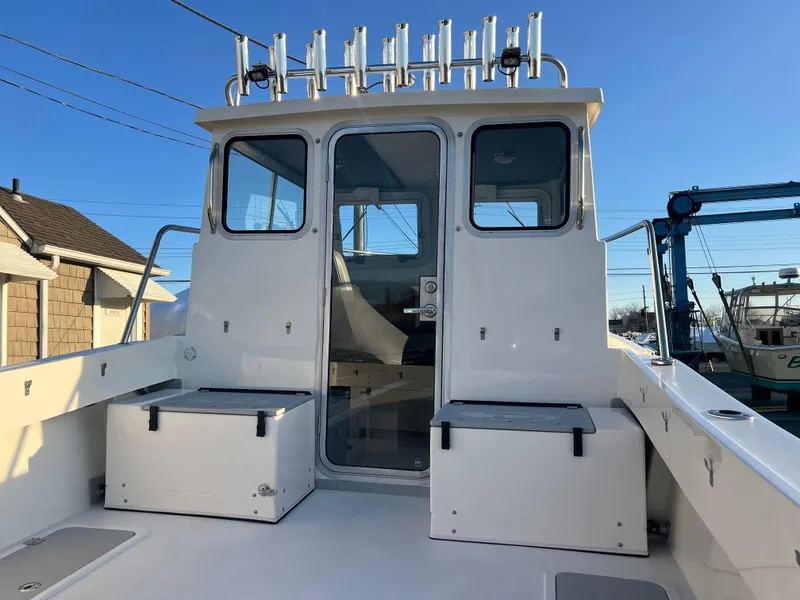 Slide: The Image of 2025 Defiance Admiral 220 EX boat with spacious deck and rod holders. - 8