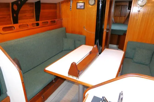 Slide: The Image of Interior of 1971 Ericson 39 Flush Deck sailboat with green seating and wooden accents. - 14